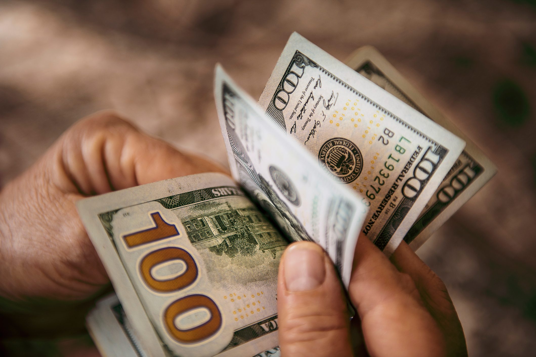 Unrecognizable mature man counting USA Dollar bills