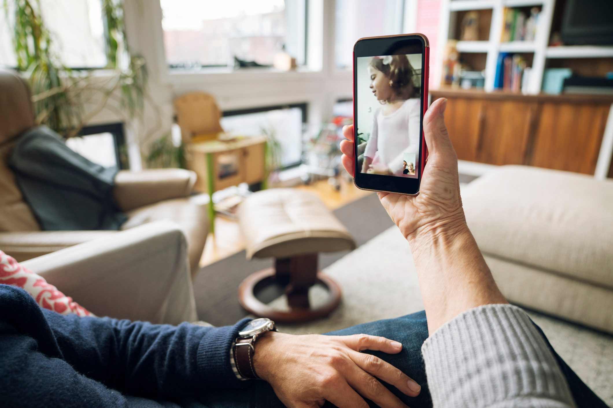 Cropped image of senior couple video conferencing at home