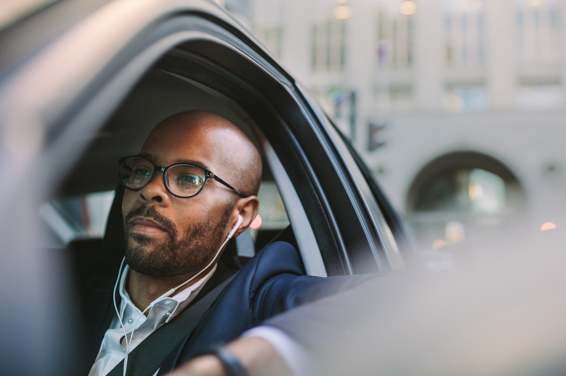 Relaxed businessman traveling by a car