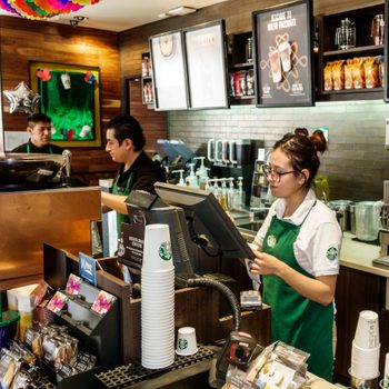 Employee baristas inside Starbucks Coffee