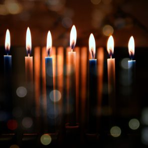 atmosheric shot of a fully lit hanukkah menorah with some bokeh effects