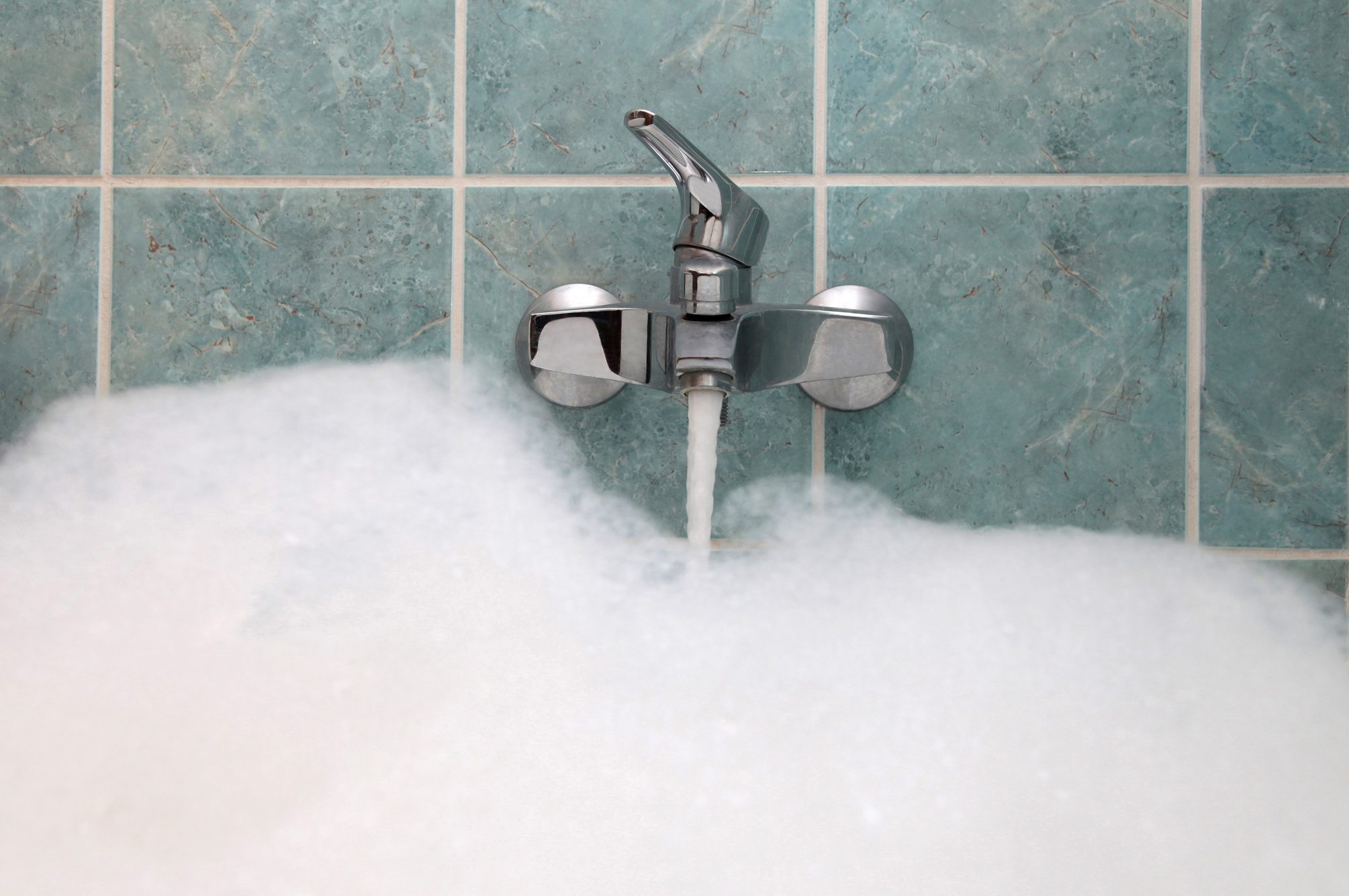 Close up of a bathtub filling with water
