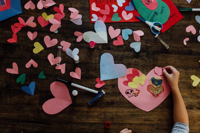 Overhead view of girl creating valentines crafts and cards