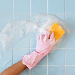 Hand in pink glove with sponge washing