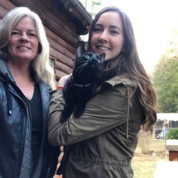 Salem, the cat treated with CBD, held by his owner