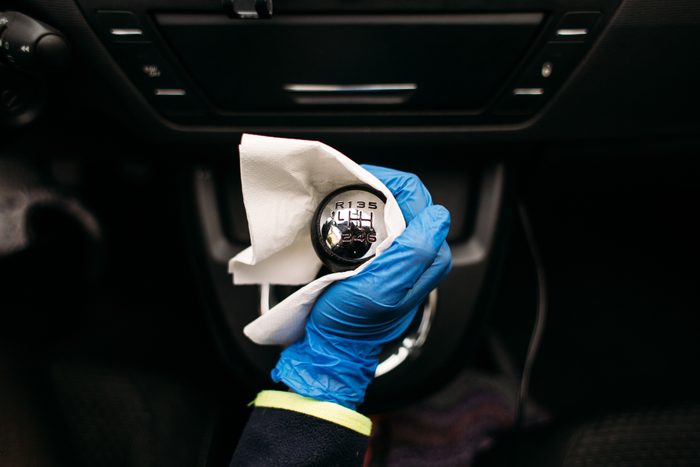 Wiping down gear shift lever in a car