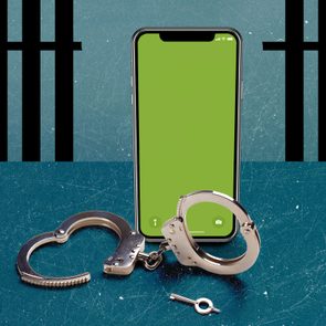 jailbroken iphone standing over unlocked handcuffs with broken jail bars in the background