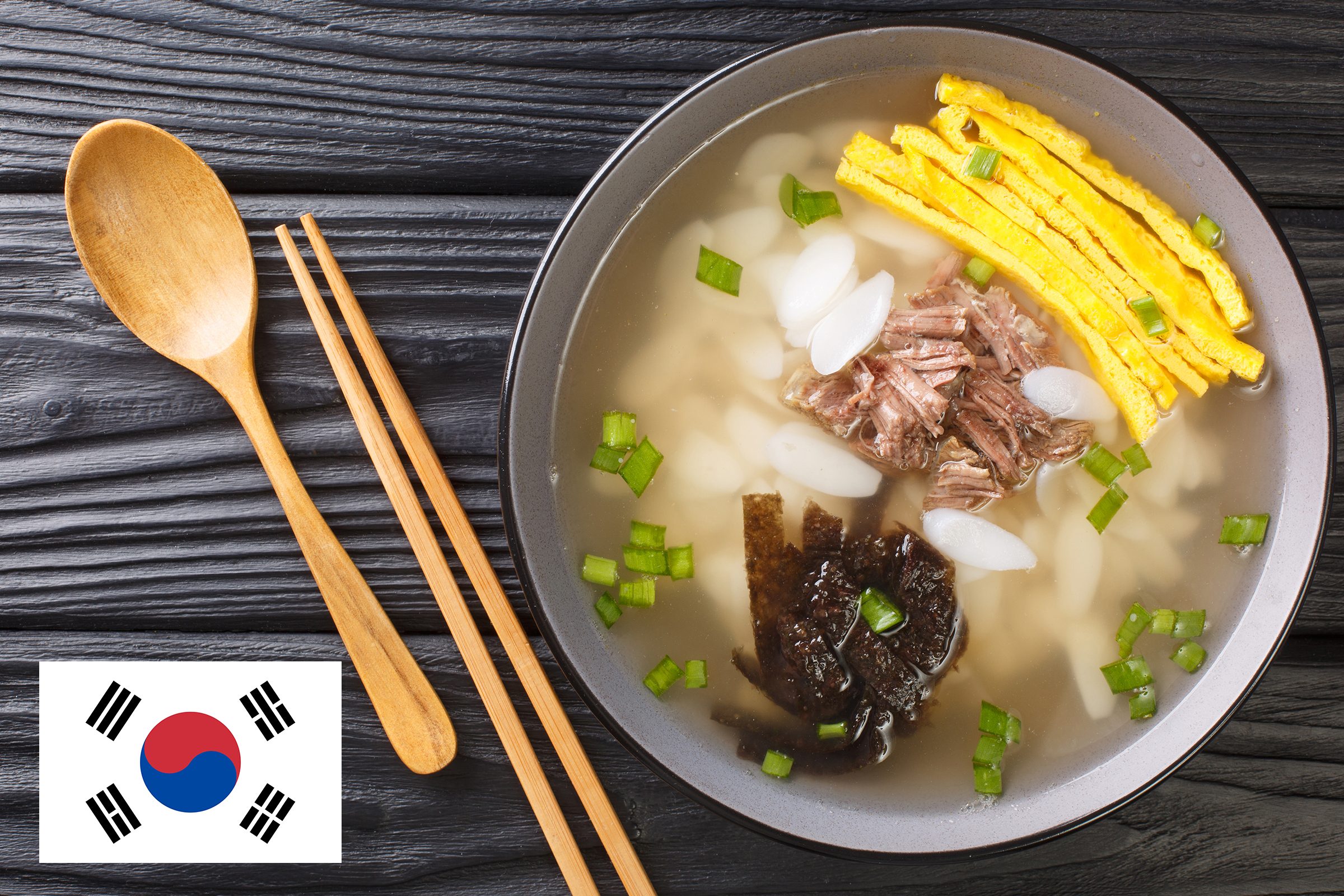 bowl of south korean soup with flag of south korea