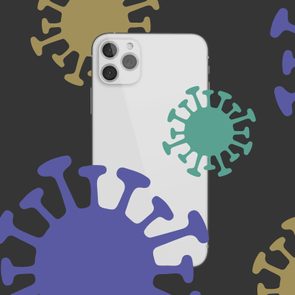 iPhone 12 surrounded by virus molecules on a dark background