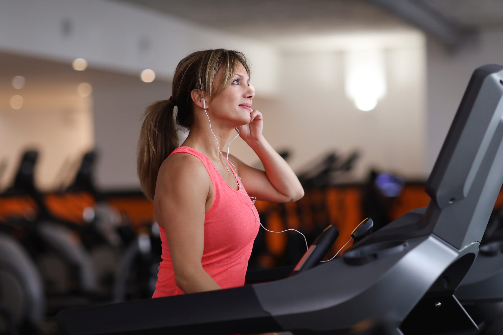 Woman walking on treadmill at fitness center