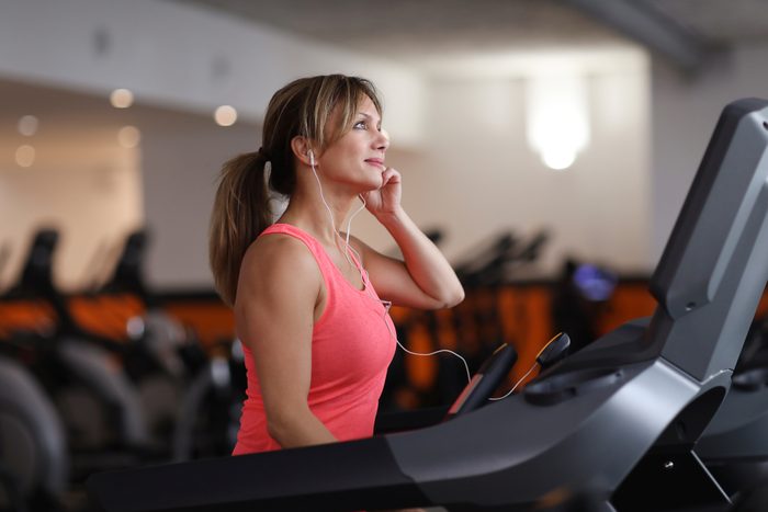 Woman walking on treadmill at fitness center