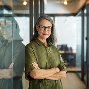 Confident mature businesswoman with arms crossed