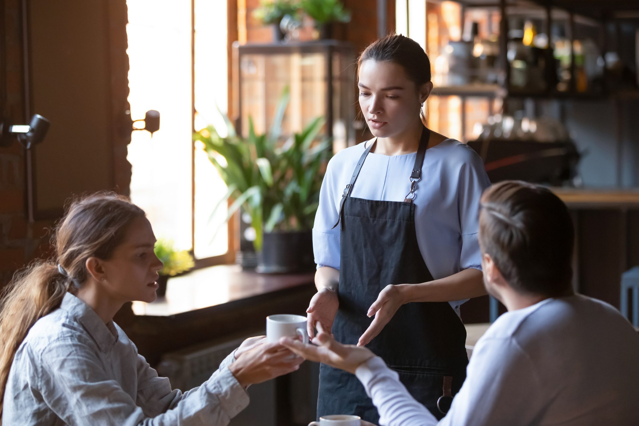 Angry client couple complain about bad service to waitress