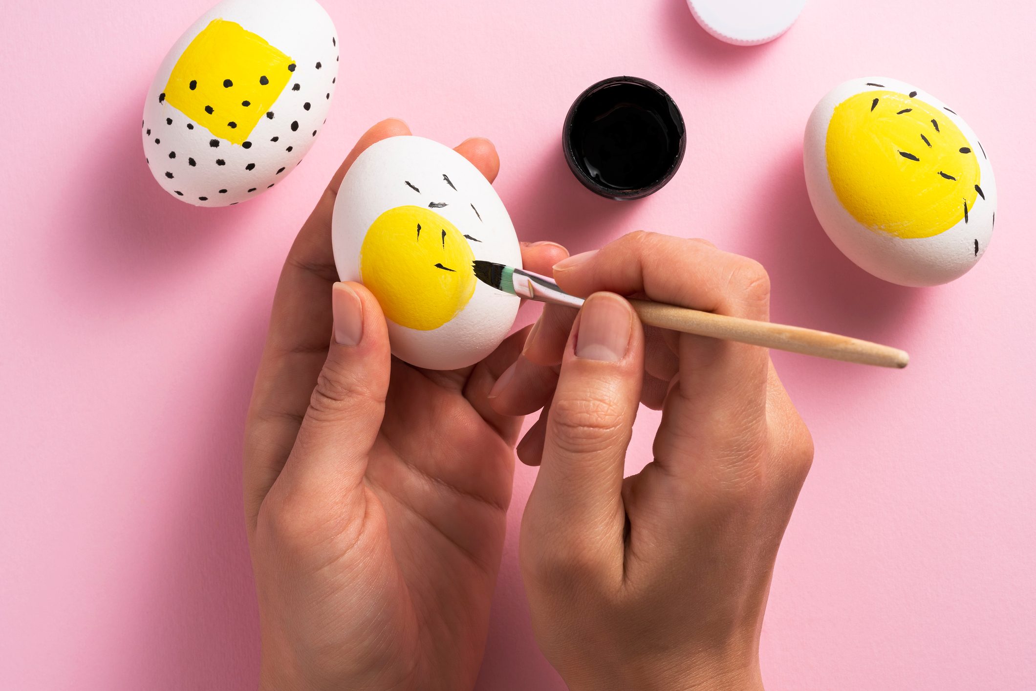 Painting easter eggs with a large yellow spot on each