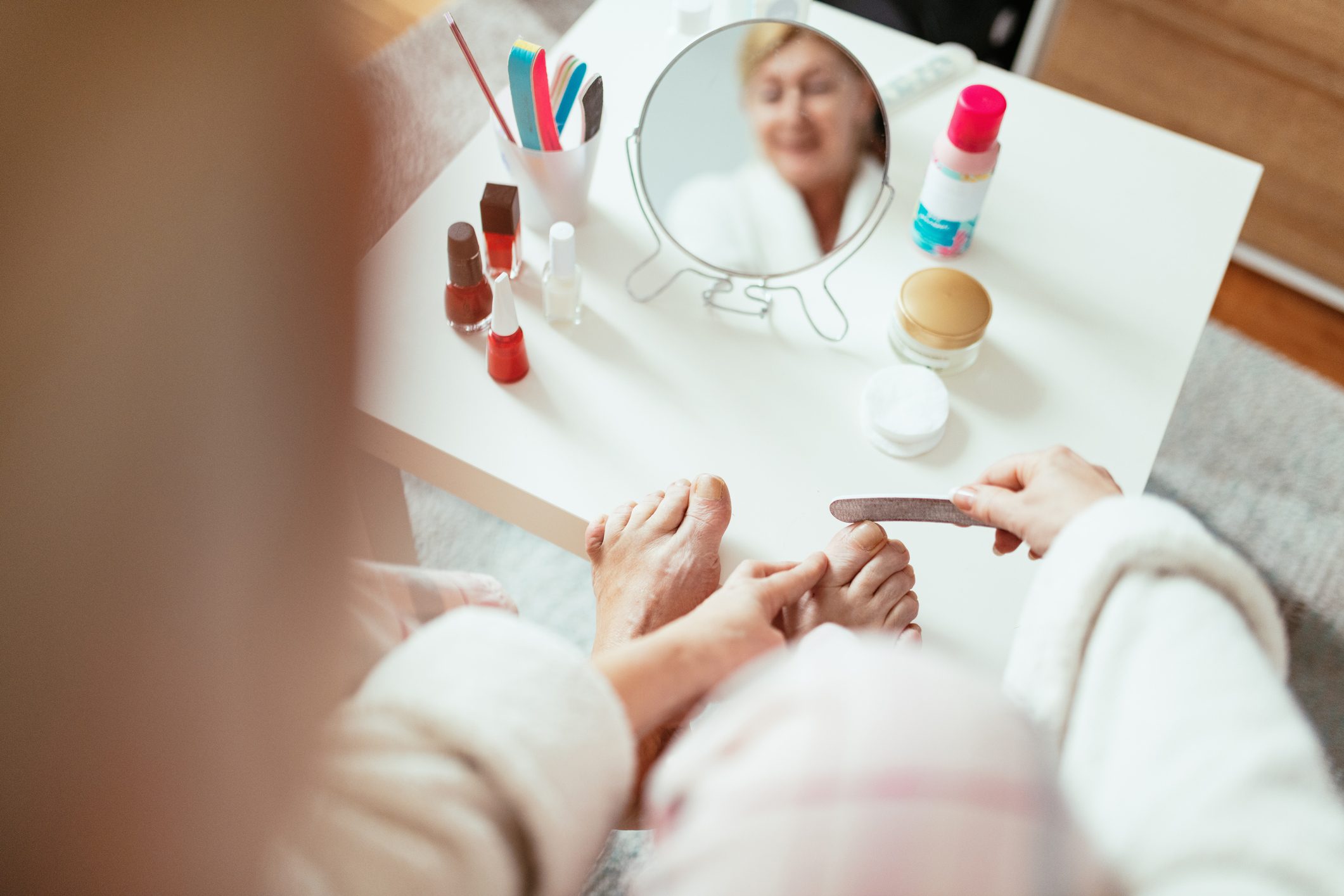 Mature woman having beauty treatment at home