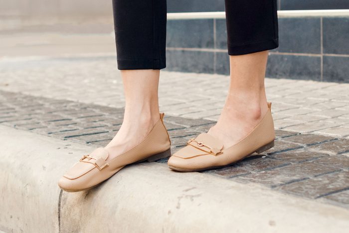woman wearing dress pants with tan shoes and ankles showing