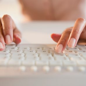 woman typing on keyboard