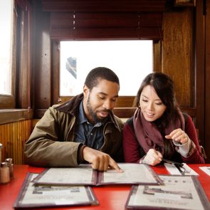 Couple looking at menu while sitting in restaurant