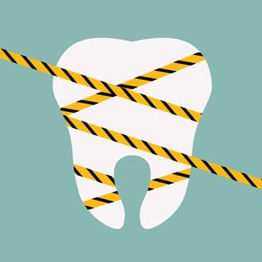 illustrated tooth wrapped with caution tape