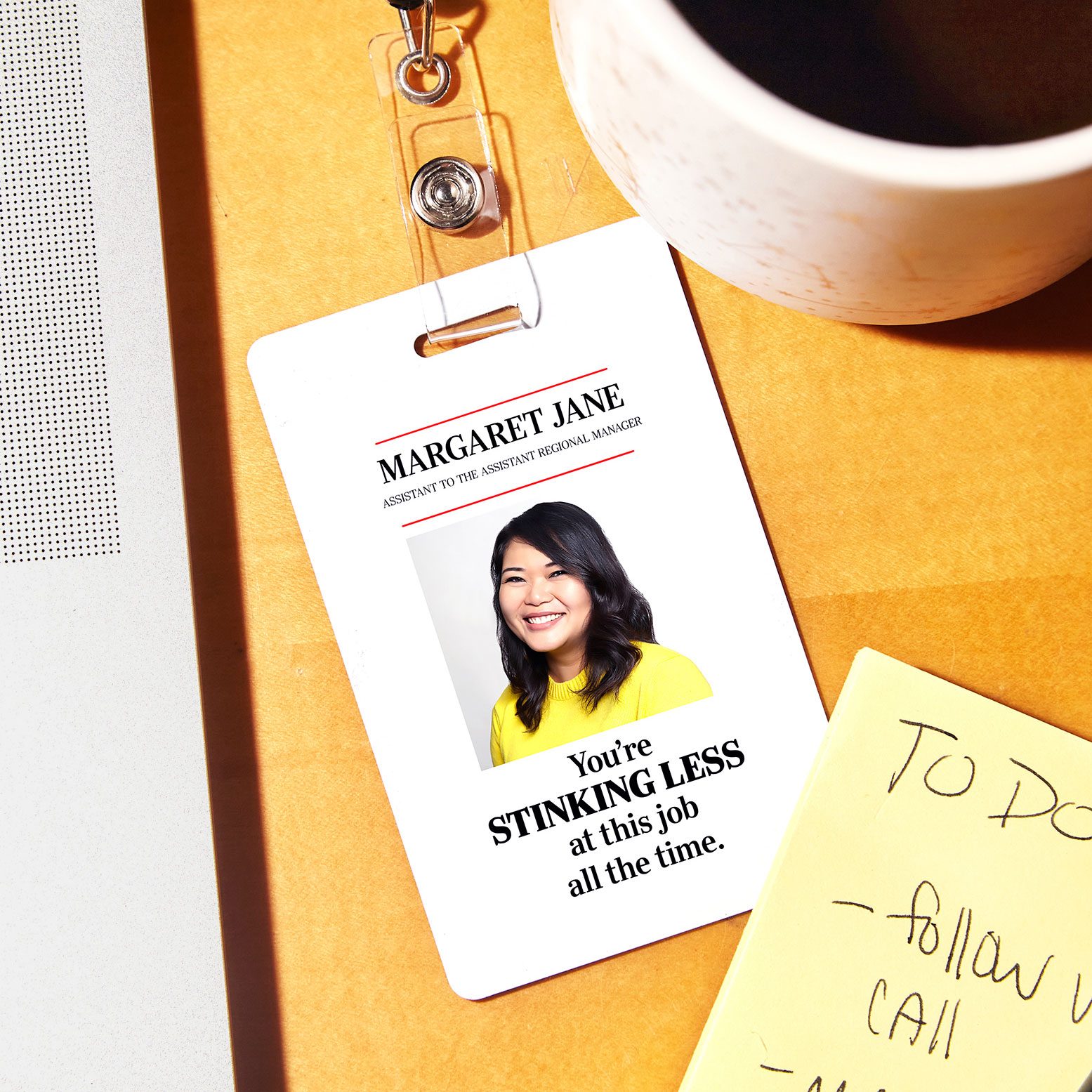 office id badge that reads, "You're STINKING LESS at this job all the time."