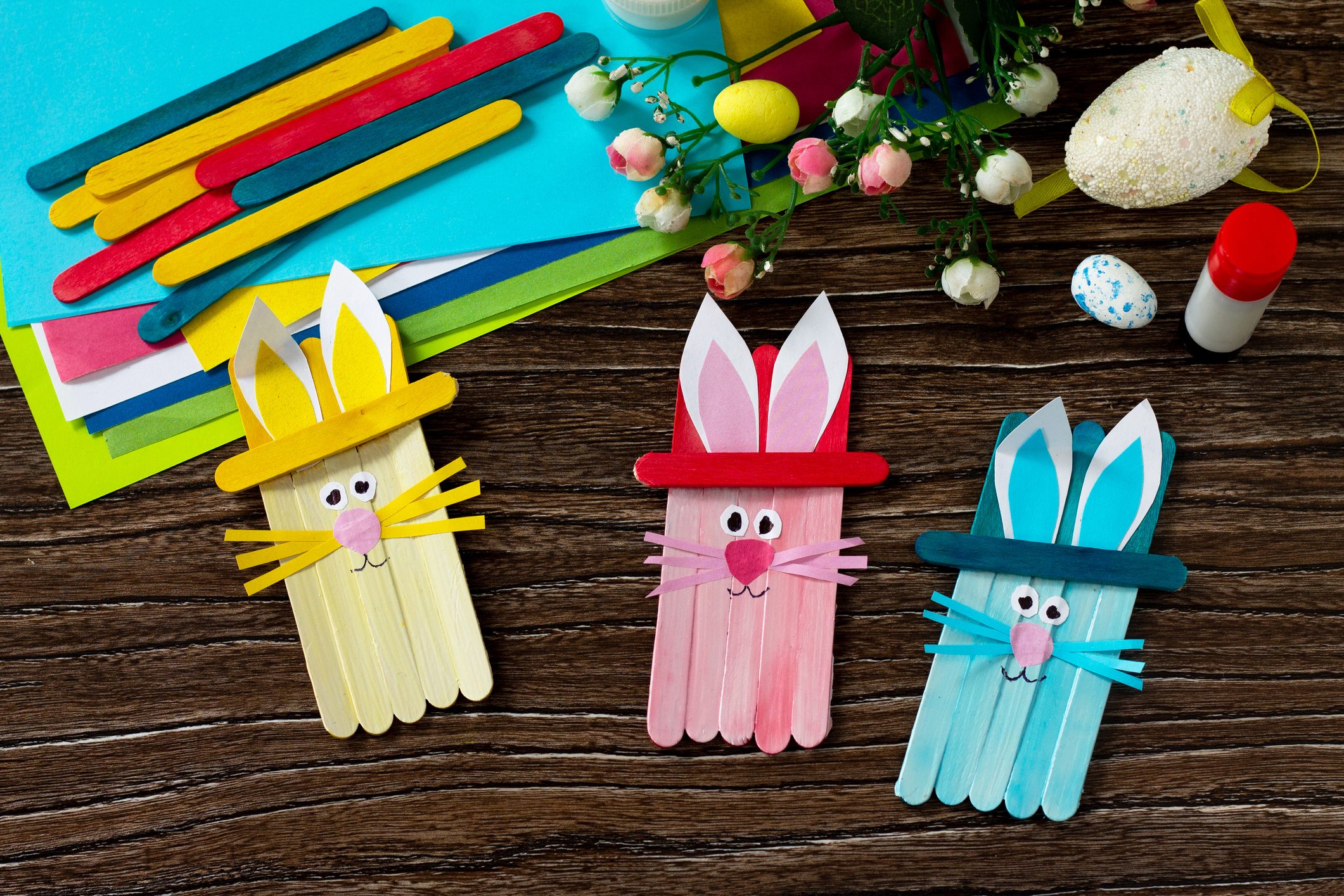 Easter bunny toy gift stics puppets on wooden table. Handmade. Project of children's creativity, handicrafts, crafts for kids.