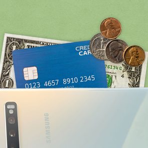 Phone with money falling out the top, symbolizing a digital wallet