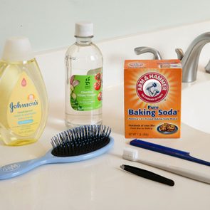 cleaning supplies next to hairbrush