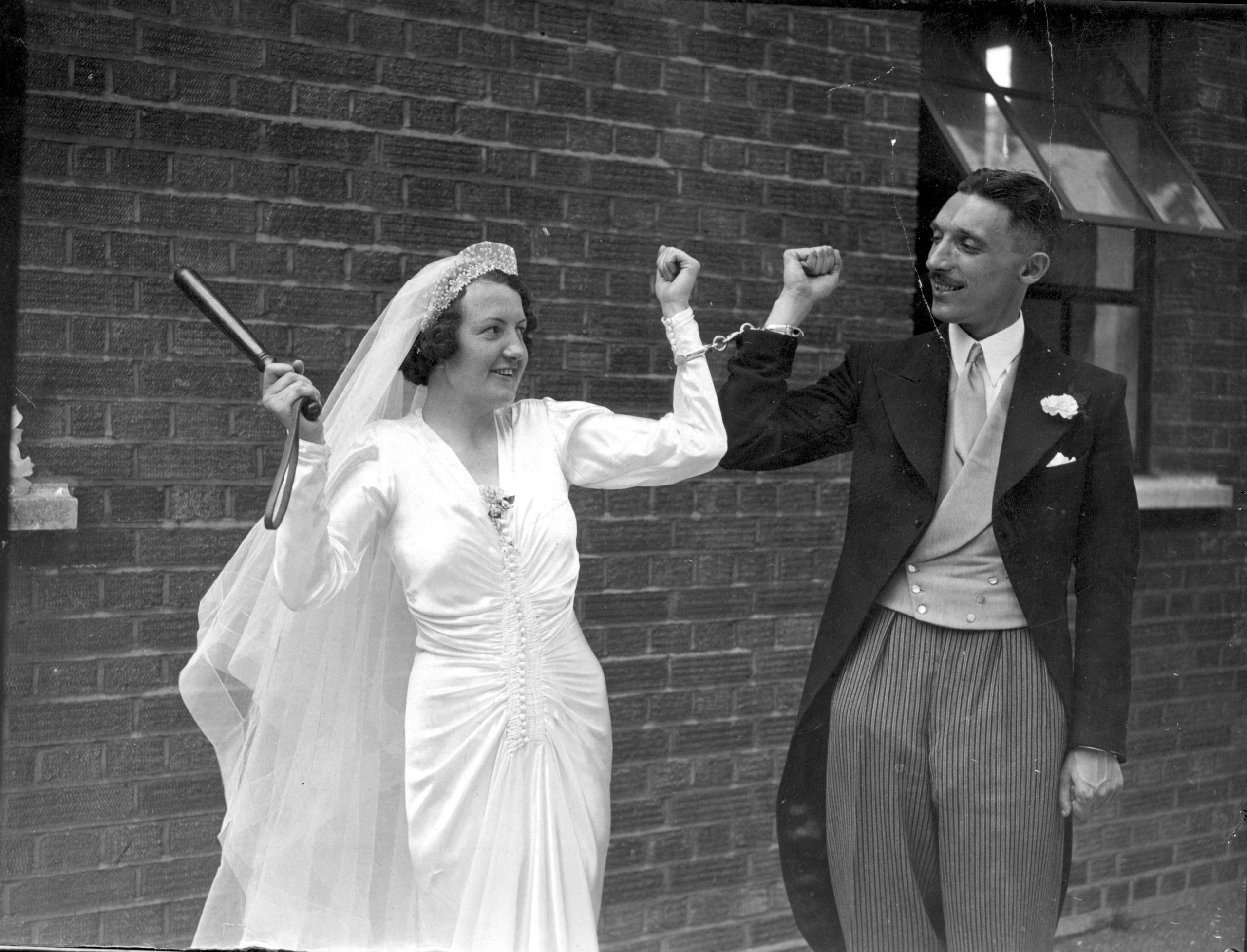 Together Forever. a bride and groom handcuffed to eachother.