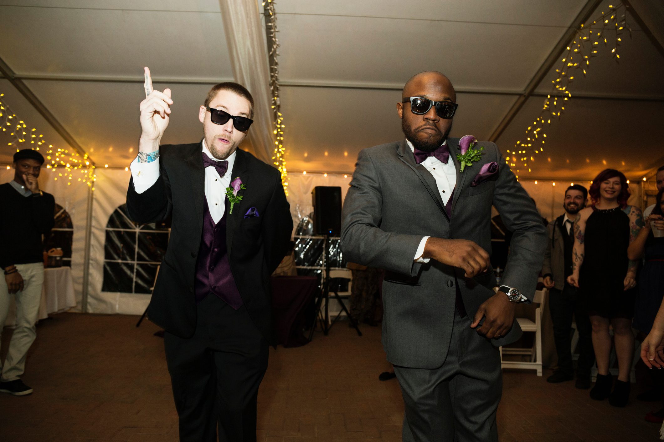 Groom and groomsman dancing at reception