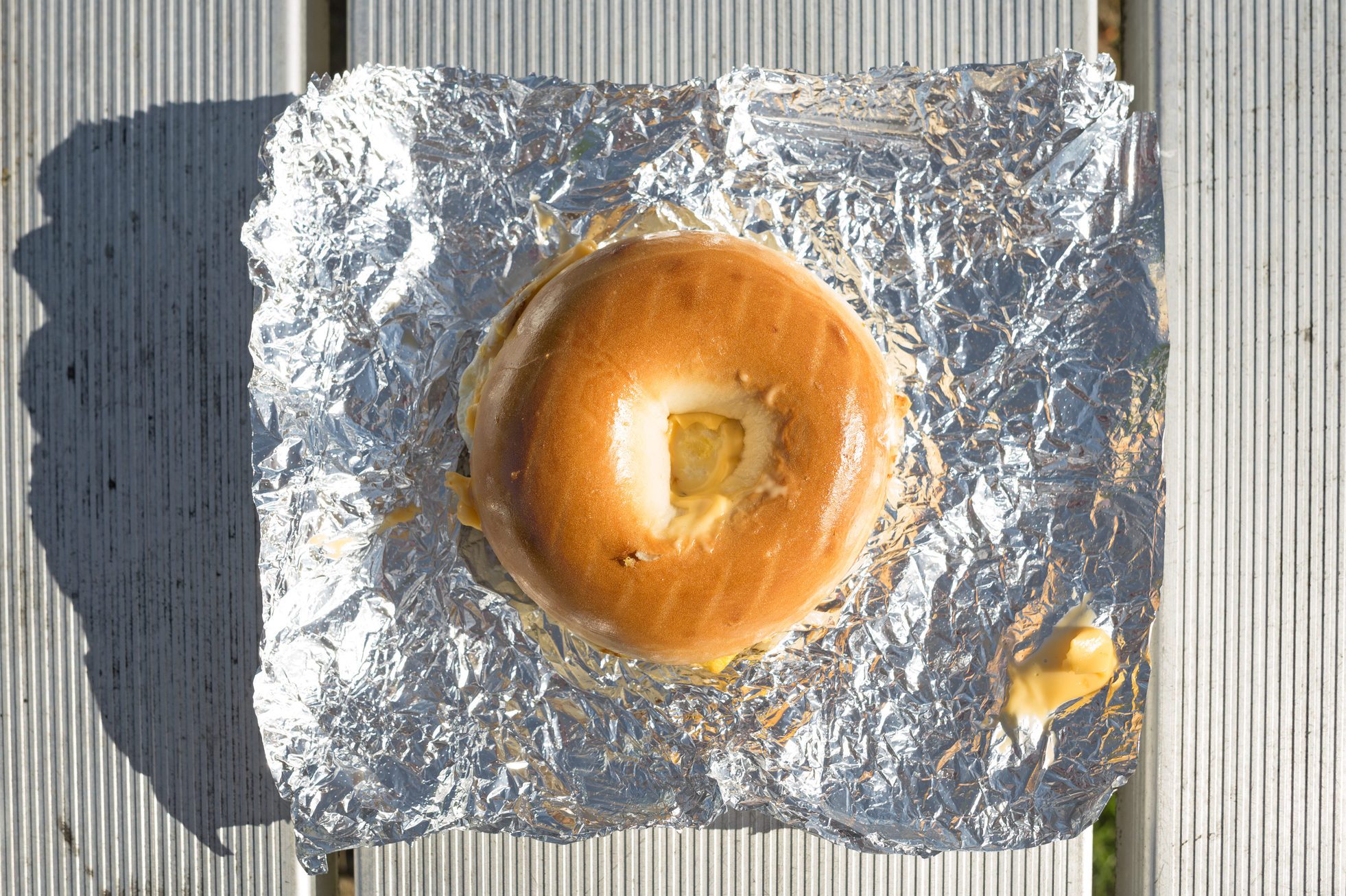 Bagel breakfast sandwich on tinfoil