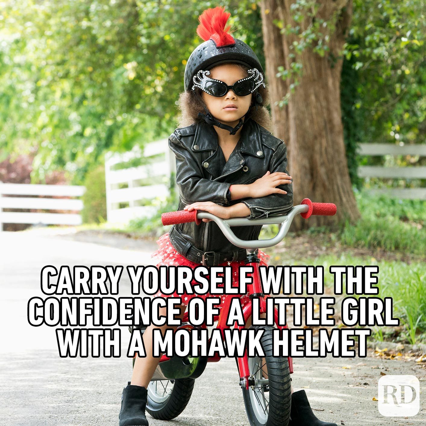 Young girl on a bike with a mohawk helmet. Meme text: Carry yourself with the confidence of a little girl with a mohawk helmet