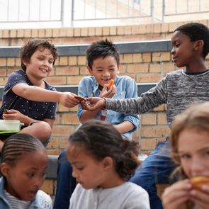 School children having lunch together outside the building