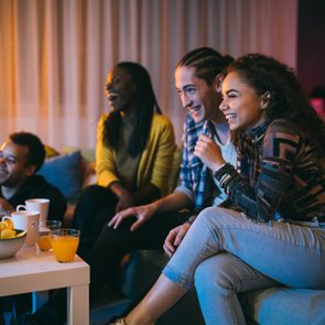 Friends watching comedy movie at home