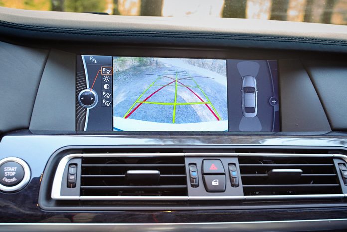 Interior of premium car with rearview camera dynamic trajectory turning lines and parking assistant. Driver assistance system for parking