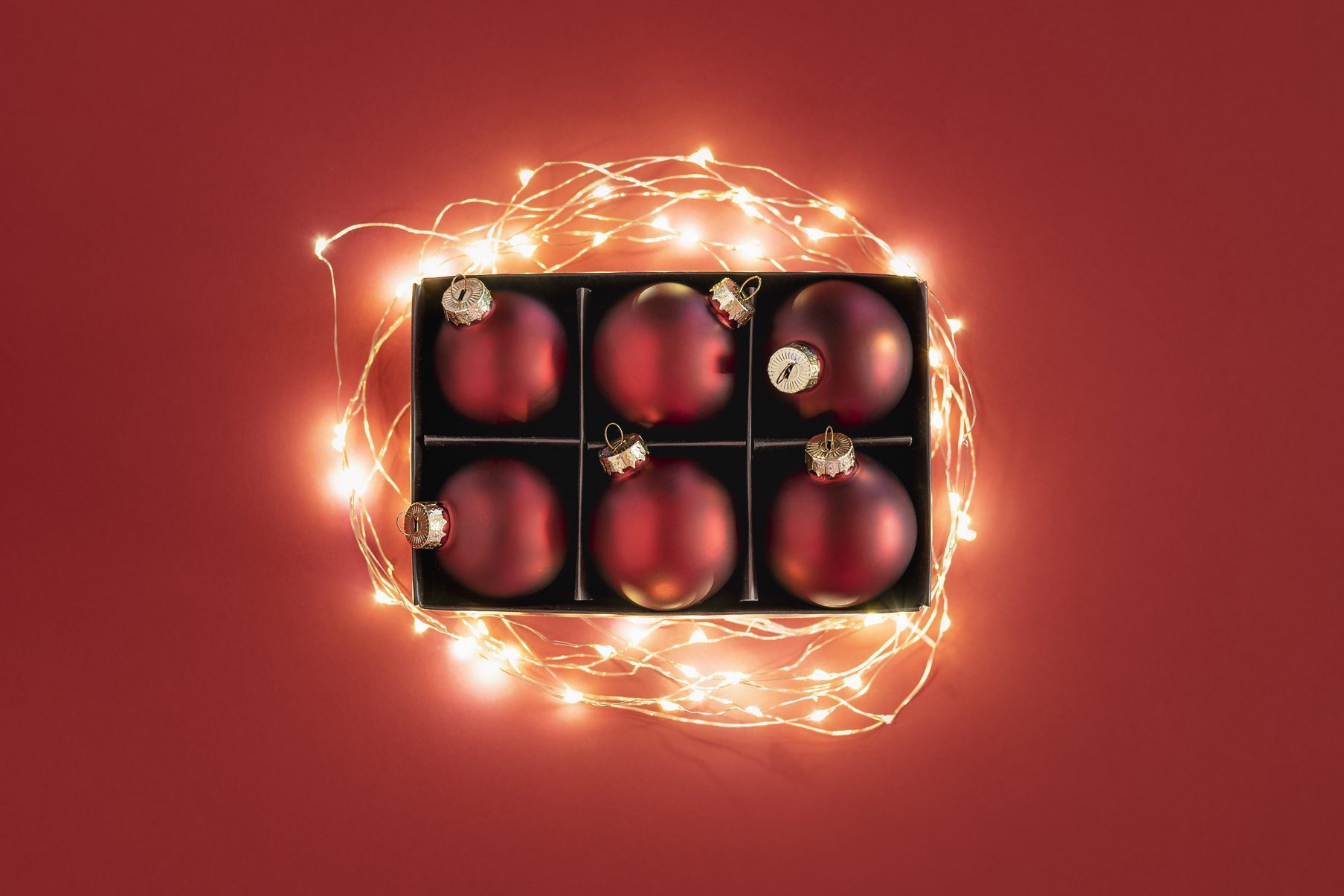 Close-Up Of Illuminated Lighting Equipment Over Red Background