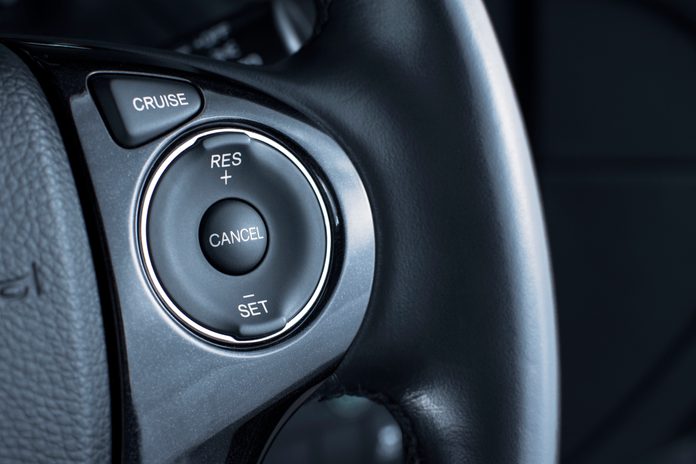 Cruise control button switch on steering wheel.