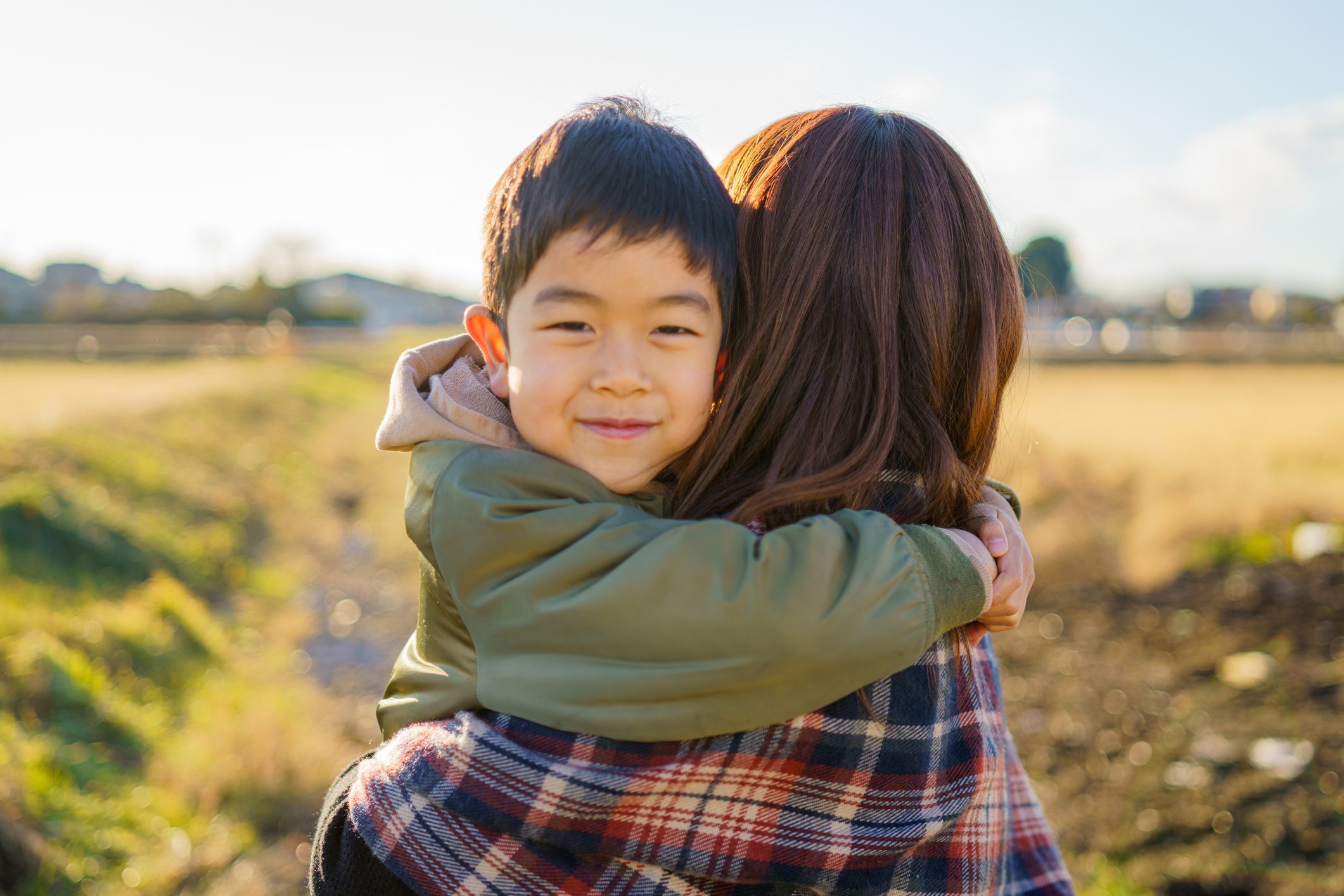 A boy hugging her mother