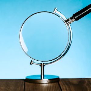 magnifying glass becomes the globe on a stand that usually holds a model of the earth