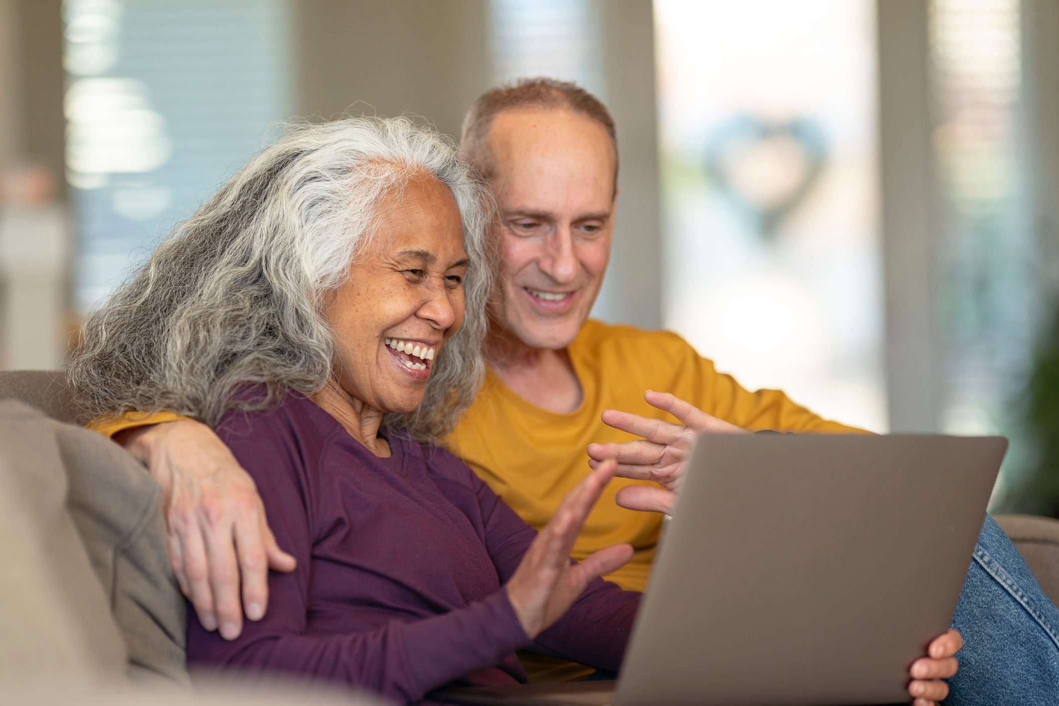 senior couple facetiming grandchildren