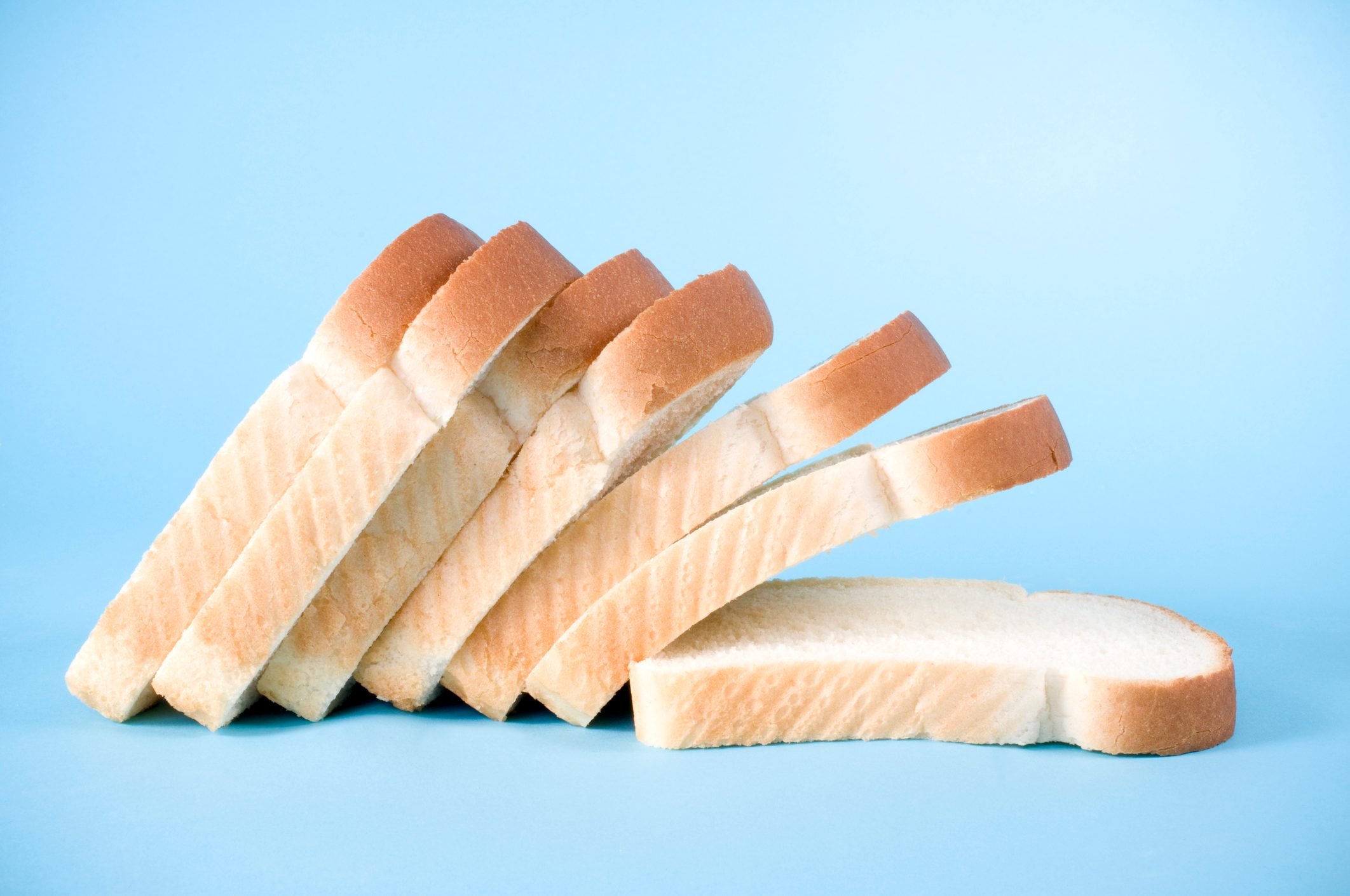 Slices of white bread on a blue background