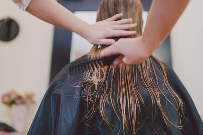 Woman getting haircut.