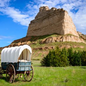 covered wagon in a field at Scotts Bluff National Monument in Nebraska along the Oregon Trail