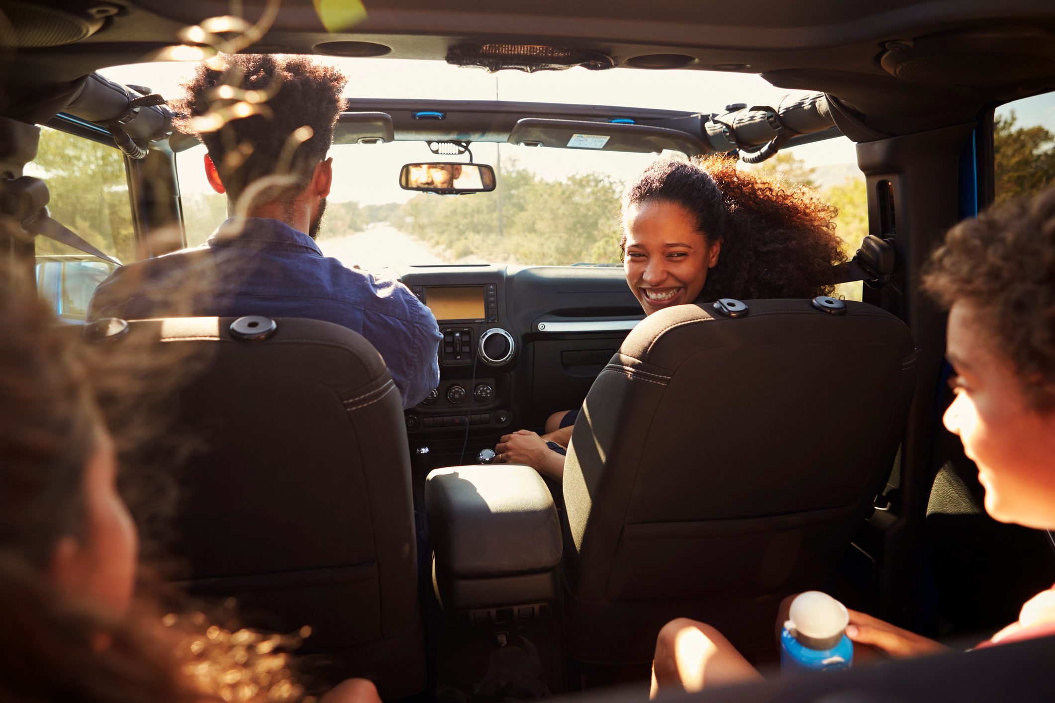 Excited family on a road trip in car