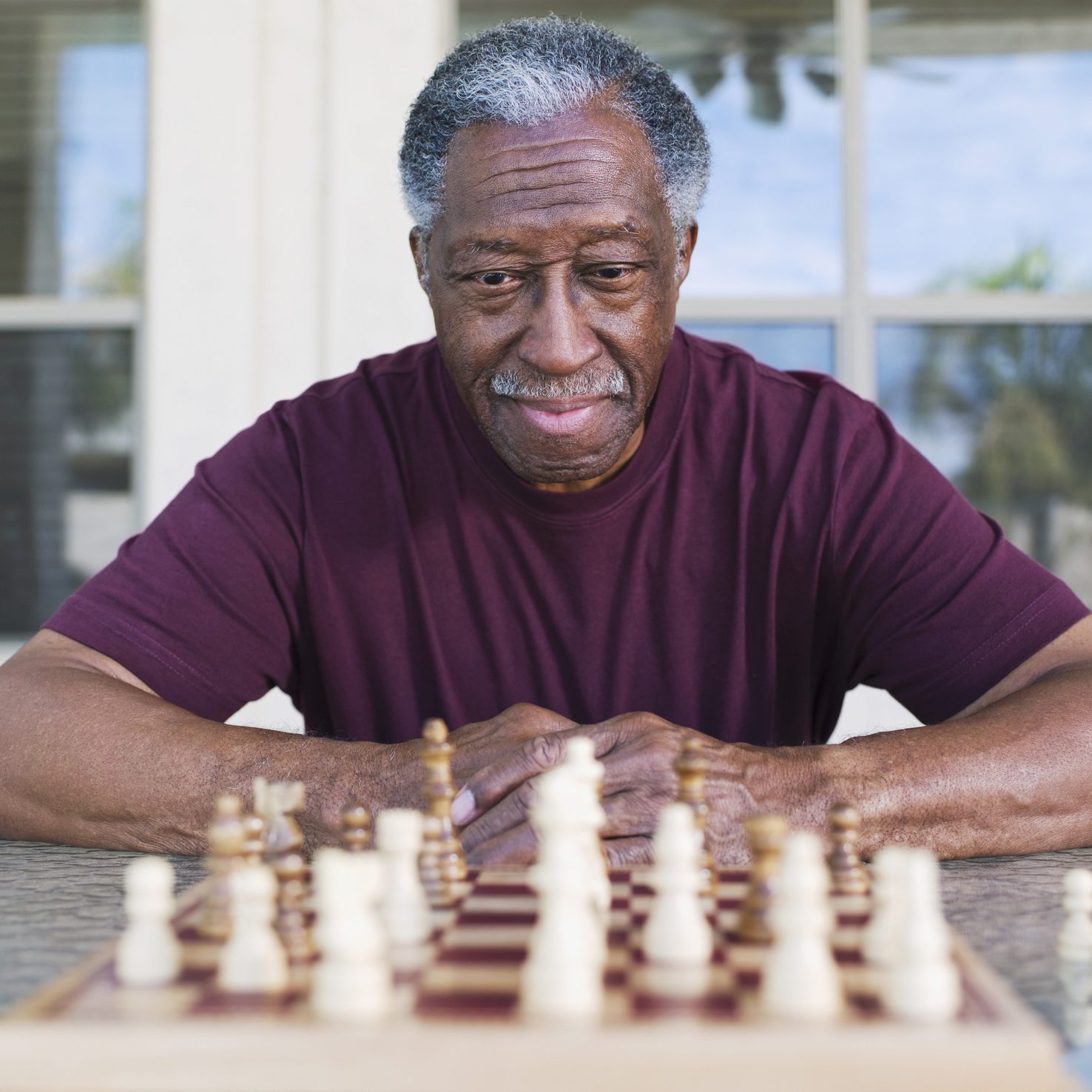 Senior African man playing chess