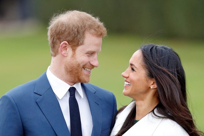 Prince Harry and Meghan Markle smile at each other