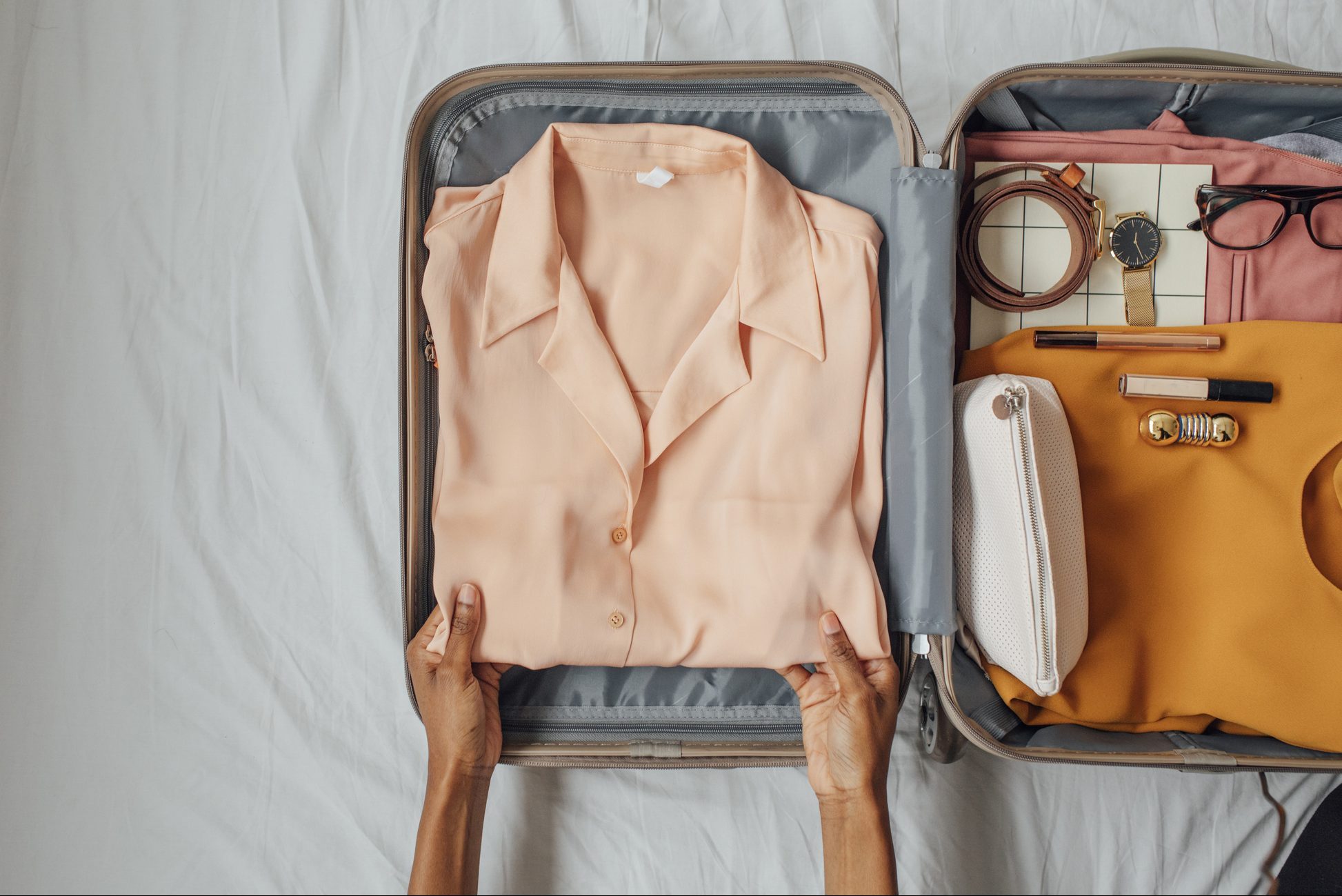 A Woman Packing her Clothes in a Suitcase