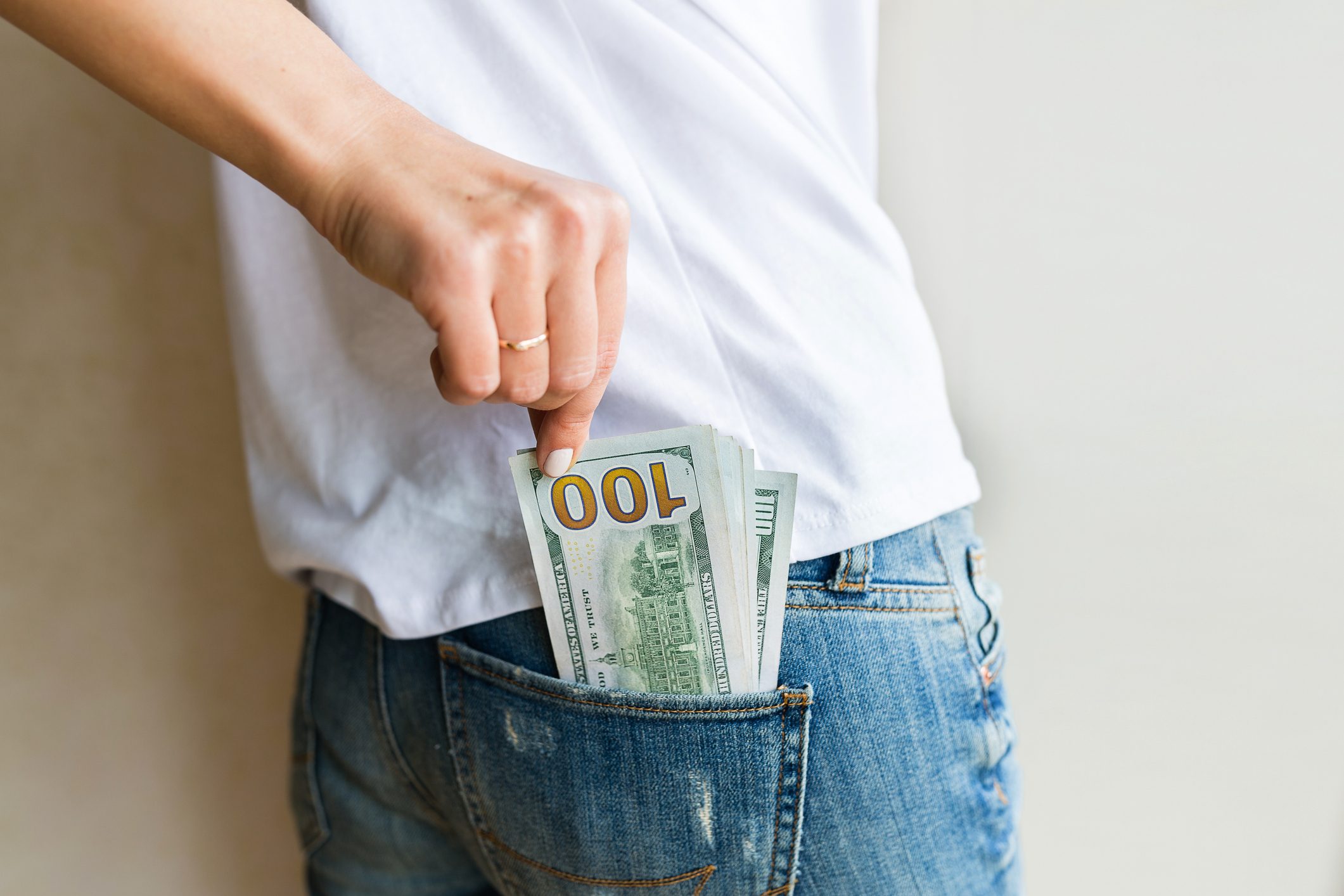 woman got cash money. Richness and wellbeing concept. Get cash money easy and quickly. one hundred dollar bills is in back pocket of jeans. Financial banking, shopping, business concept