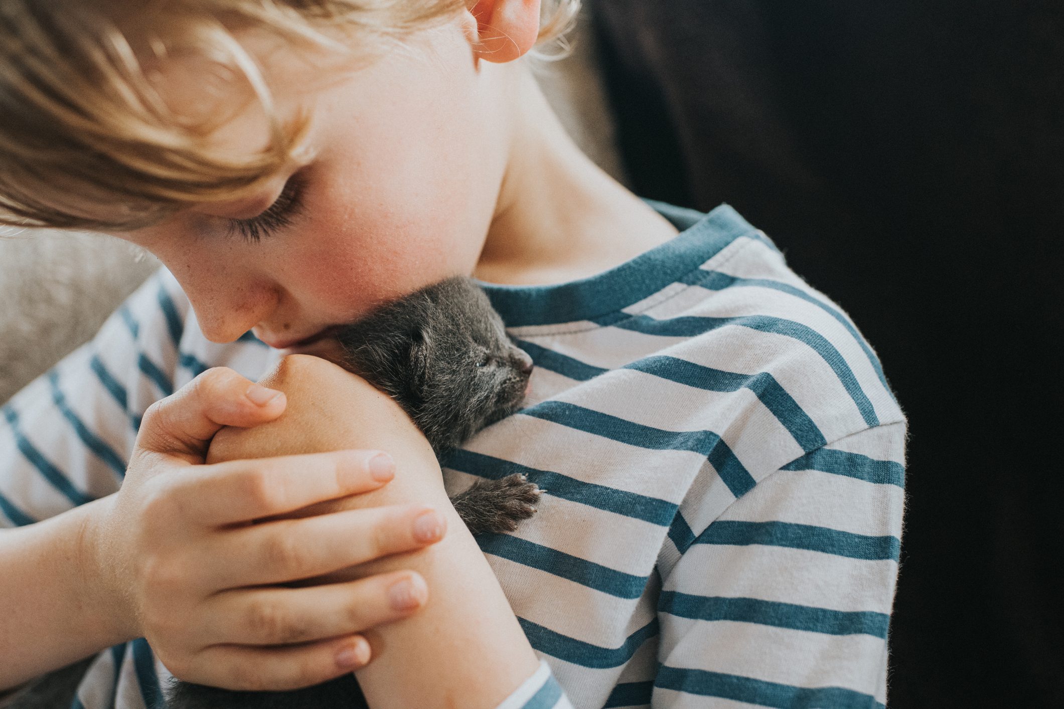 Boy holding a Tiny Newborn Kitten