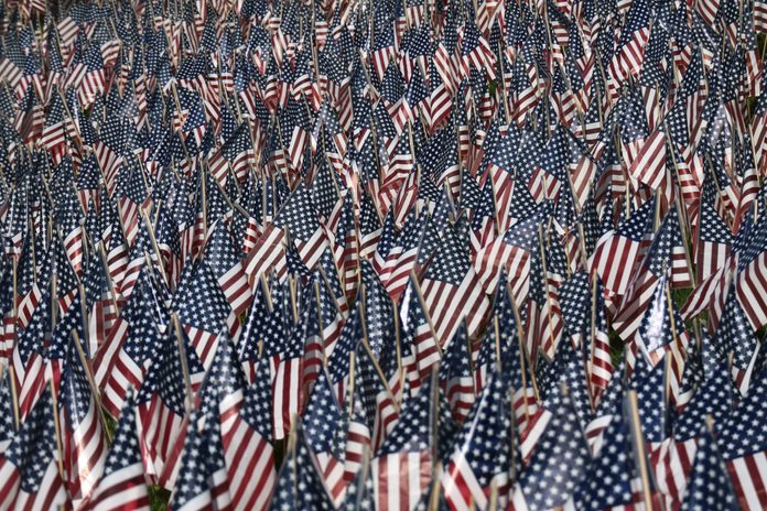 Thousands of US flags decorate the front lawn of the Fort Lee High School in advance of election day and Veterans Day on November 6, 2016 in Fort Lee, NJ.