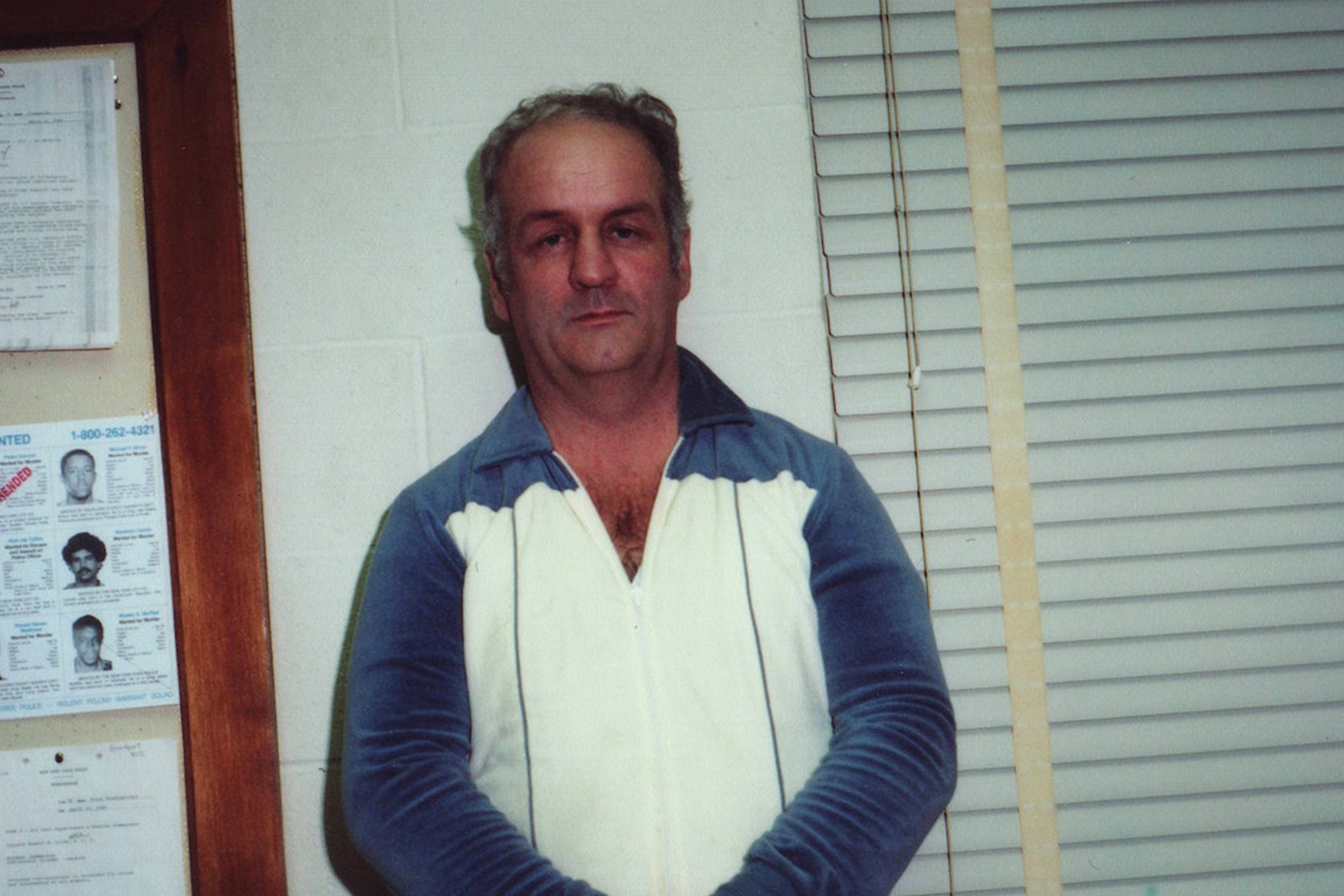 man standing next to investigation board